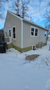 Home exterior renovation featuring new siding and foundation work by Clausen Construction LLC in Williston, ND