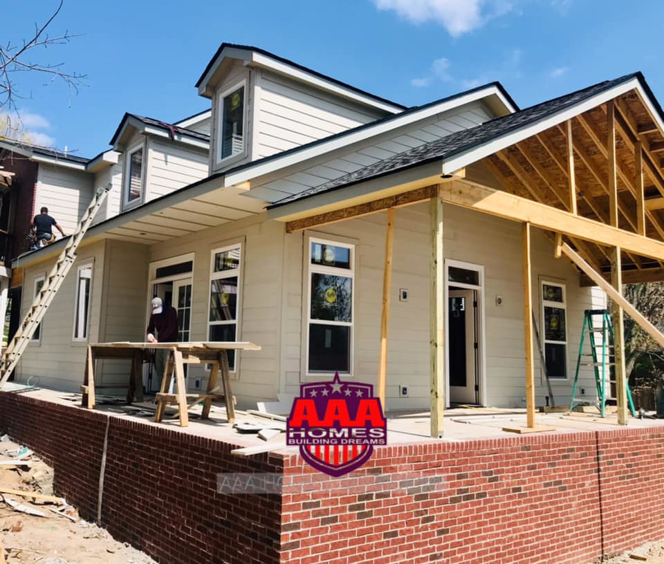 Workers installing exterior siding on a home construction project by AAA HOMES LLC in Franklin, TN.