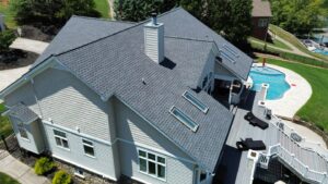 A house with green garage doors and a new roof completed by Innovative Roofing & Siding Inc in Knoxville, TN.