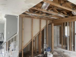 Home interior framing and exposed ceiling with ductwork near a staircase by Wise Construction Group in Atlanta, GA.