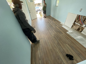 J8 General Construction performing an interior home renovation with new flooring and drywall work in San Antonio, TX.