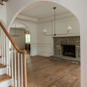 Home interior renovation showcasing a stone fireplace, hardwood floors, and a new staircase by Brentwood Builders Inc. in Lancaster, PA.