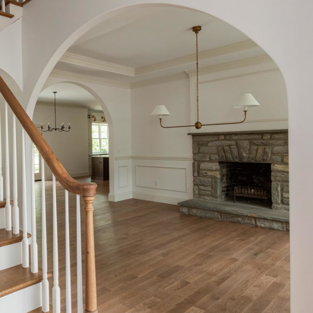 Home interior renovation showcasing a stone fireplace, hardwood floors, and a new staircase by Brentwood Builders Inc. in Lancaster, PA.