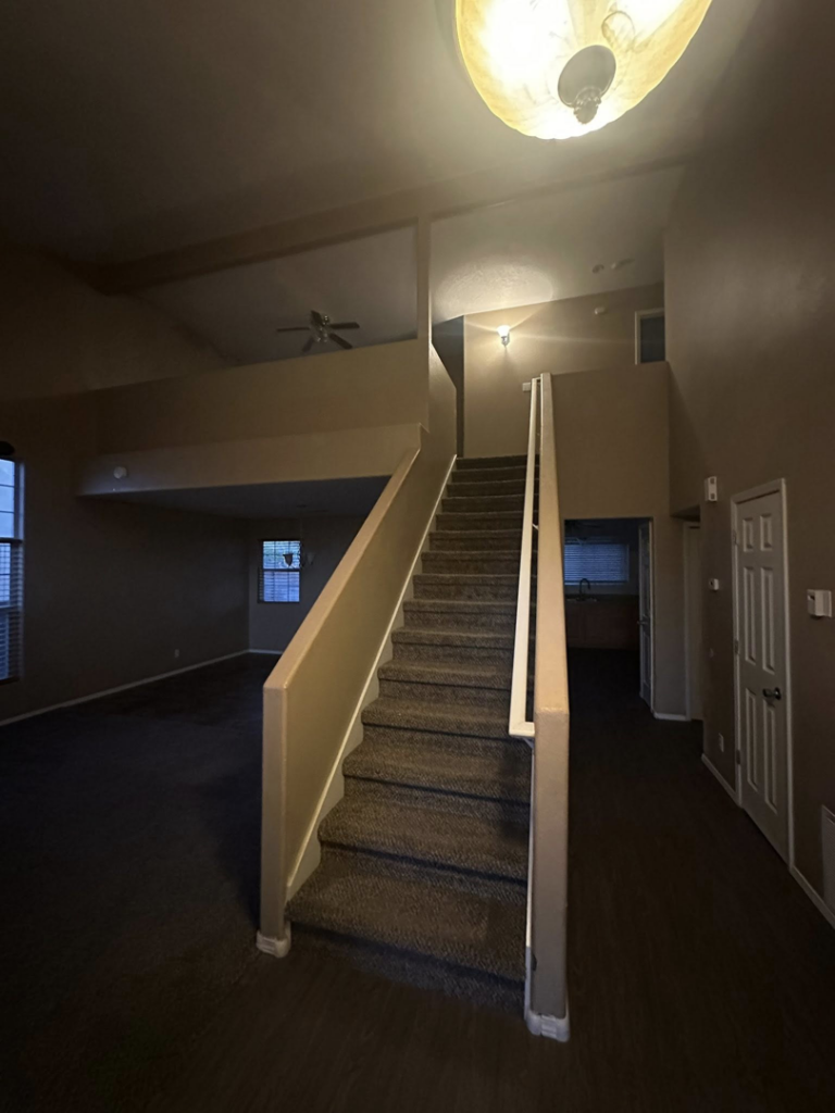 A home interior showing a staircase, ready for or after painting services by Appleton Residential Services in Rio Rancho, NM.