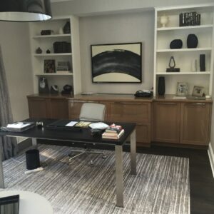 A home office featuring custom built-in desk and shelving units by Connaughton Construction in Waltham, MA