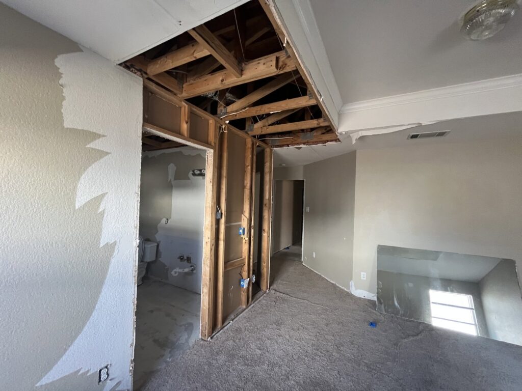 Home renovation with ceiling removed and wall framing exposed by San Marcos Drywall and Paint in Austin, TX