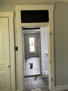 A home renovation project showing new door trim installation and painting prep by JW Contracting Services, LLC in Dayton, OH.