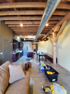 An ongoing home renovation project with exposed wooden beams, ductwork, and tools on the floor by Lilac Remodel Spokane in Spokane Valley, WA.