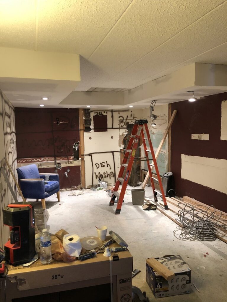 Home renovation project in progress, showing exposed walls and construction materials by Segovia LLC interiors in Madison, WI.