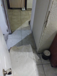 A home renovation project showing floor protection and a paint can by TaylorMade handyman services in Roswell, NM