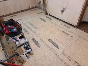 A home renovation project showing new subfloor installation and tools by Vest Home Services LLC in Greenville, SC.