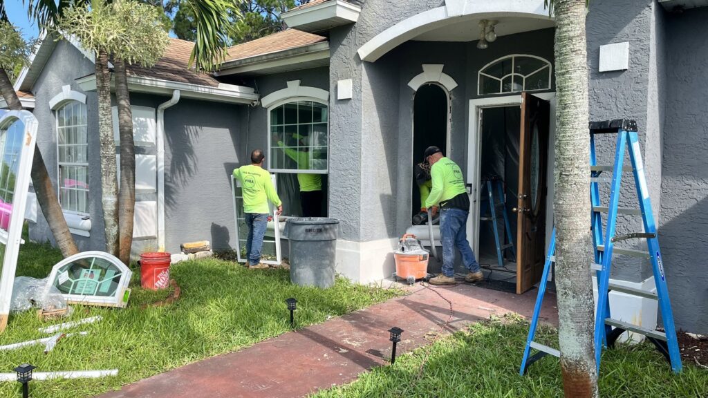 Workers performing home window and door replacement services by FHIA Remodeling in Fort Lauderdale, FL