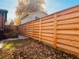 A modern horizontal slat wood fence installed by GreenView Solutions in Denver, CO, for privacy.