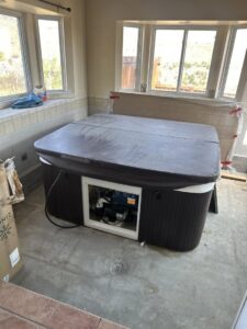 A hot tub located inside a room, awaiting professional removal services from Hagen's Junk Removal in Fort Collins, CO.