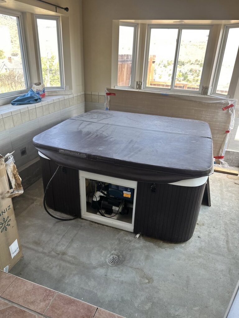 A hot tub located inside a room, awaiting professional removal services from Hagen's Junk Removal in Fort Collins, CO.