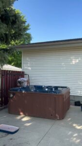 A Junk Haulin Heroes team member dismantling a hot tub for removal in Bismarck, ND.