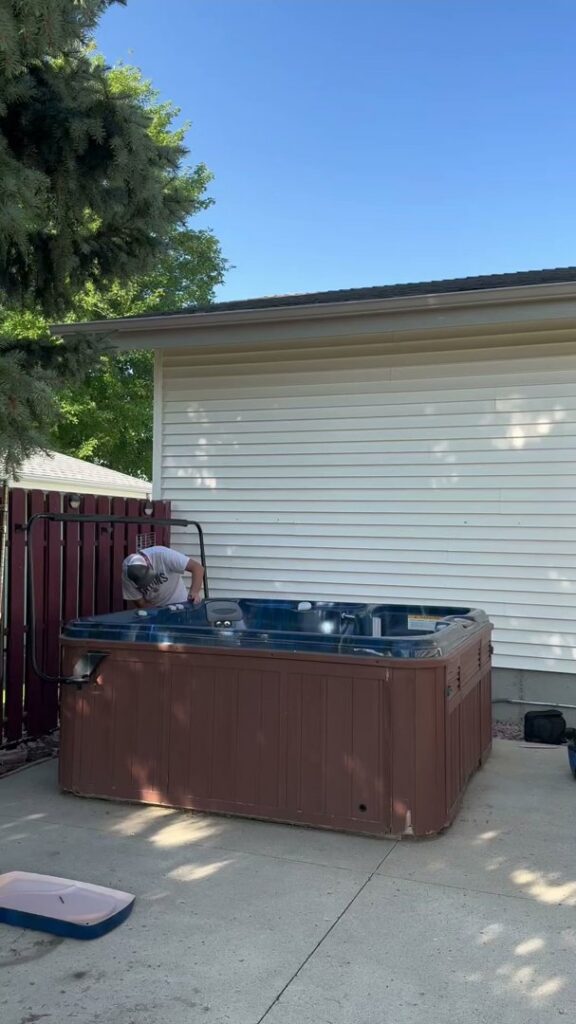 A Junk Haulin Heroes team member dismantling a hot tub for removal in Bismarck, ND.
