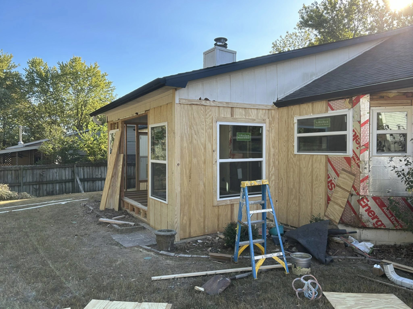 A house addition under construction with framing, new windows, and siding being installed by Old Things Created New Handyman Service in Springdale, AR.