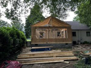 A new house addition being framed with wooden studs and roof trusses by B & S Development, Inc. in Richmond, VA