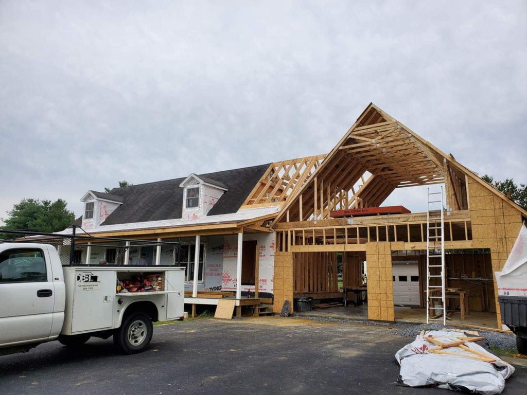 A house under construction with new framing for an addition, showcasing work by DBB, Inc. in Harrisonburg, VA.