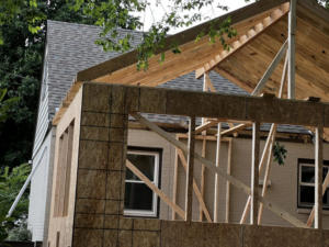 Exterior view of a house addition showing new roof framing and wall sheathing by B & S Development, Inc. in Richmond, VA