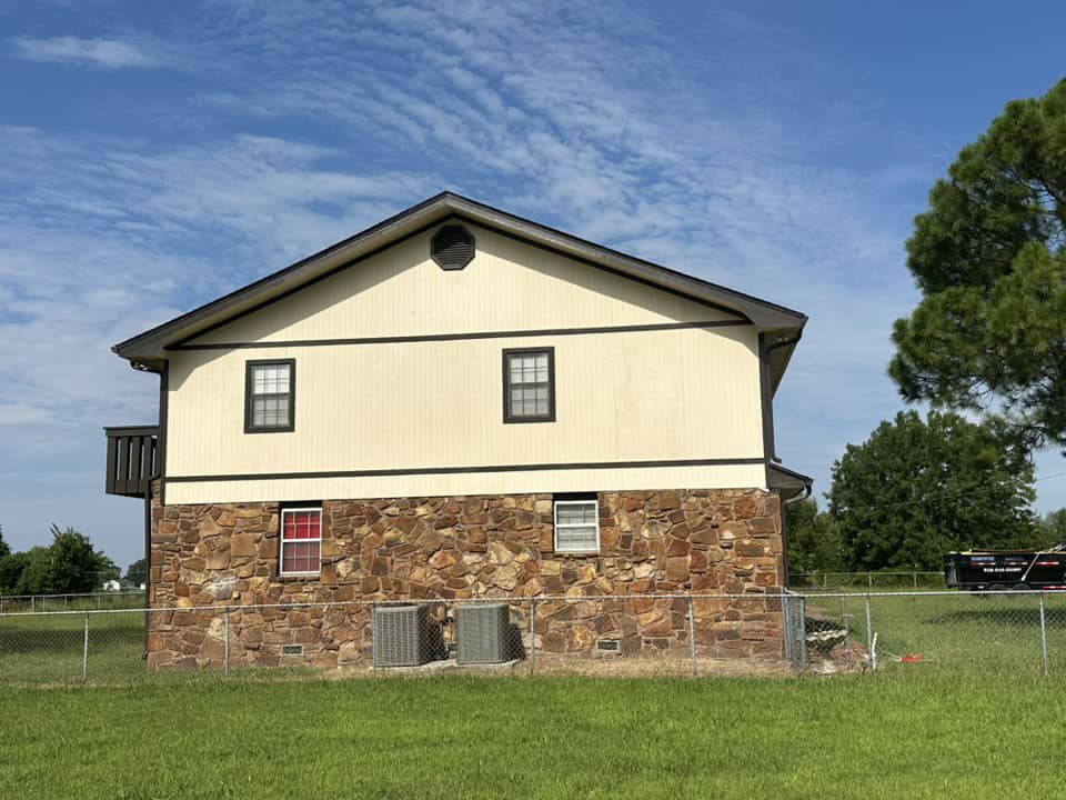 Back of a house with peeling siding and AC units, indicating a potential exterior repair job by Construction Doctor in Littleton, CO.
