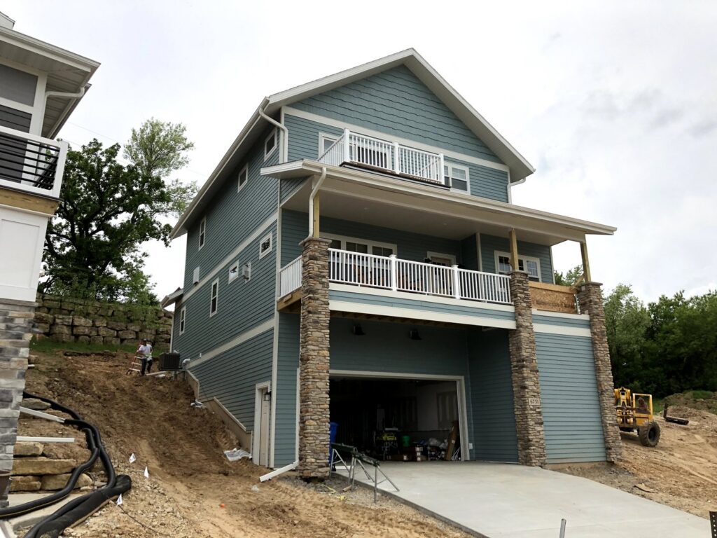 A house under construction with newly installed gutters and downspouts by Gutter Flow7 LLC in Madison, WI.