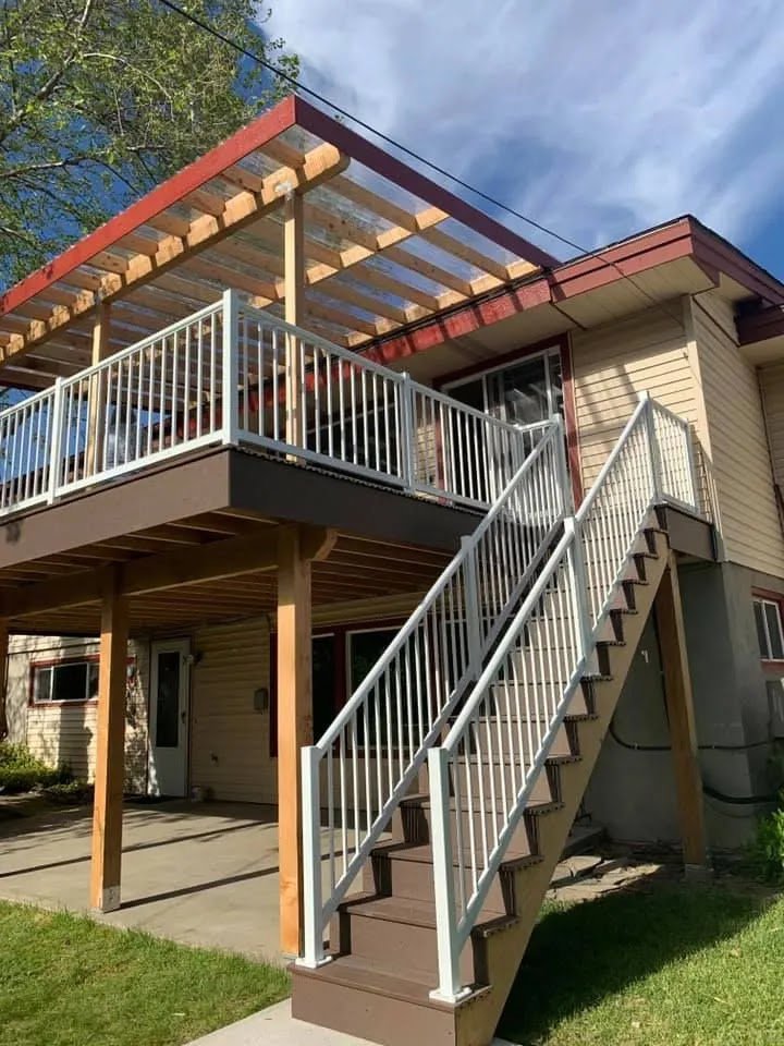 A house with a newly constructed deck and stairs, showcasing exterior work by Myers & Myers Construction in Spokane, WA.