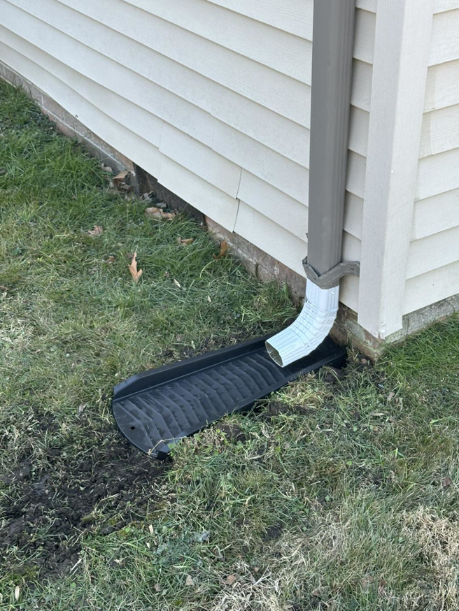 A house drainage solution installed with a downspout and channel by Jps handyman services,inc in Hampton, VA.