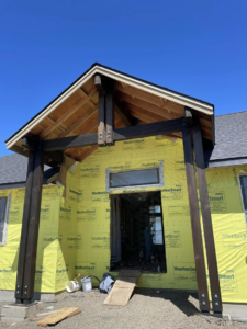 House entryway under construction with exposed wood framing and sheathing by Palma's Painting & Misc. in Corvallis, OR.