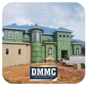 Exterior of a house under construction with siding and roofing work in progress by DMMC LLC in Kansas City, MO