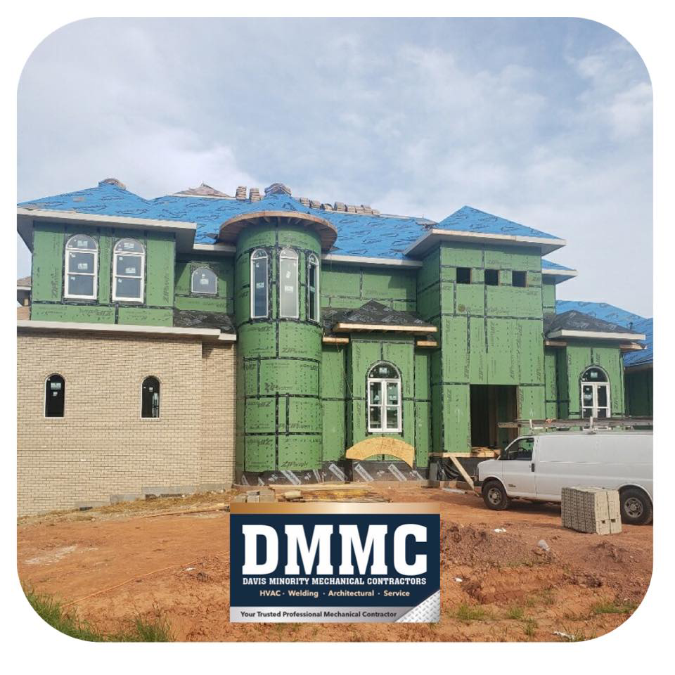 Exterior of a house under construction with siding and roofing work in progress by DMMC LLC in Kansas City, MO