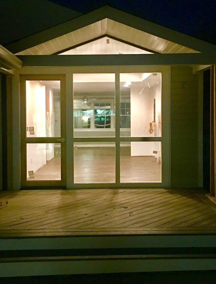 Exterior view of a house with a newly built deck and visible interior renovation work by The Womack Group / Home Service Plus, LLC in Franklin, TN