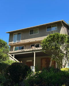 House exterior with an old deck and a ladder, showing deck renovation in progress by Rosas Construction and Renovation in Dallas, TX.