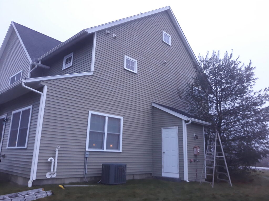 A ladder leaning against the side of a house, indicating exterior handyman services by Phoenix's Cleaning Service, LLC in Rutland, VT.