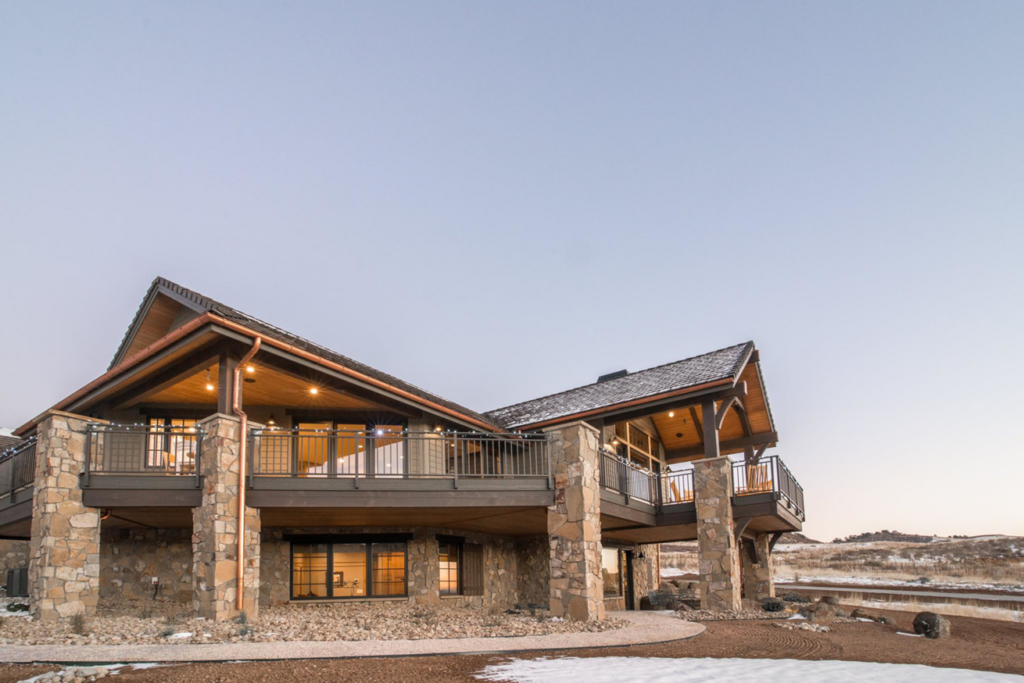 The exterior of a home showcasing multiple decks and copper gutters installed by Lee Barker Builder LLC in Fort Collins, CO.