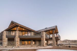 The exterior of a home showcasing multiple decks and copper gutters installed by Lee Barker Builder LLC in Fort Collins, CO.