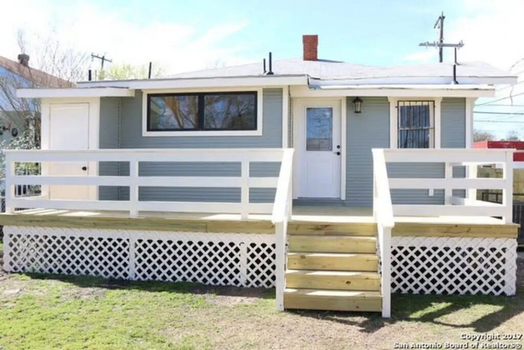 The exterior of a renovated house with a newly built white deck and stairs by Morin Construction LLC in San Antonio, TX