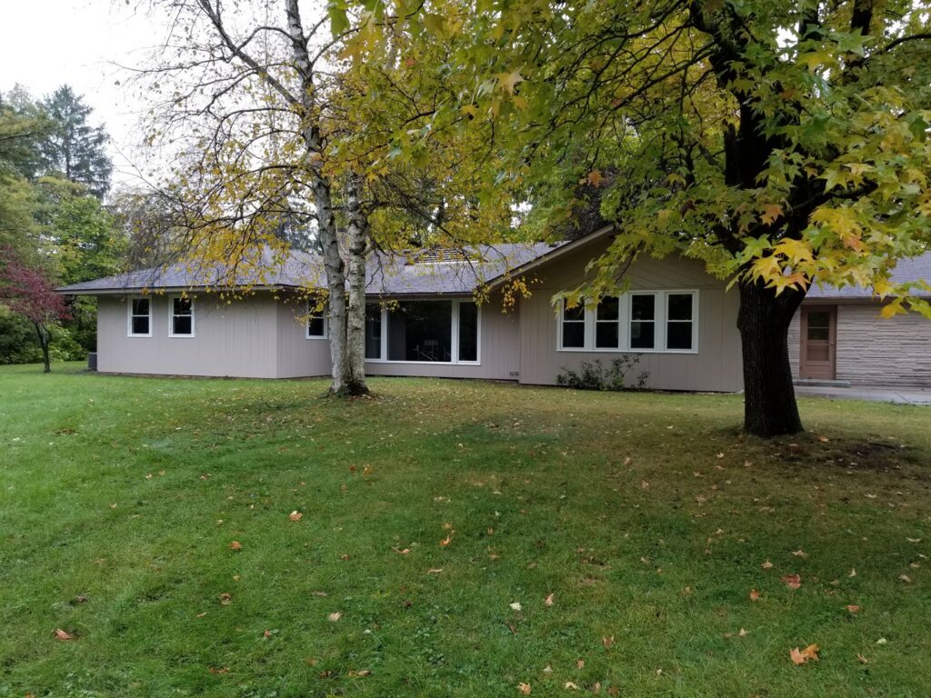 Exterior view of a house with newly installed windows and light-colored siding by The Window Man of Ohio in Westerville, OH.
