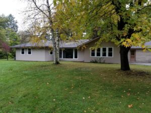 Exterior view of a house with newly installed windows and light-colored siding by The Window Man of Ohio in Westerville, OH.