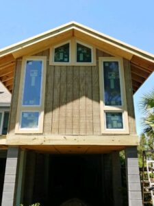 House exterior with new windows and wood siding installed by American Custom Exteriors in North Charleston, SC.