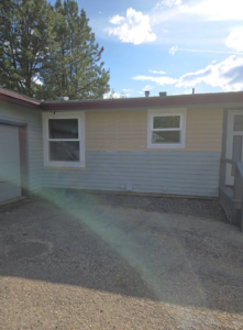 Side view of a house exterior featuring newly installed windows and updated siding by Stephen Appel Handyman/Contractor in Meridian, ID.
