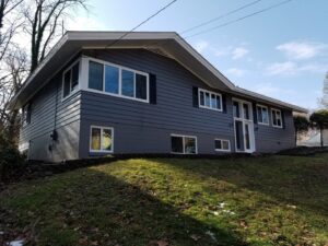 Exterior view of a house with newly installed windows and dark gray siding by The Window Man of Ohio in Westerville, OH.