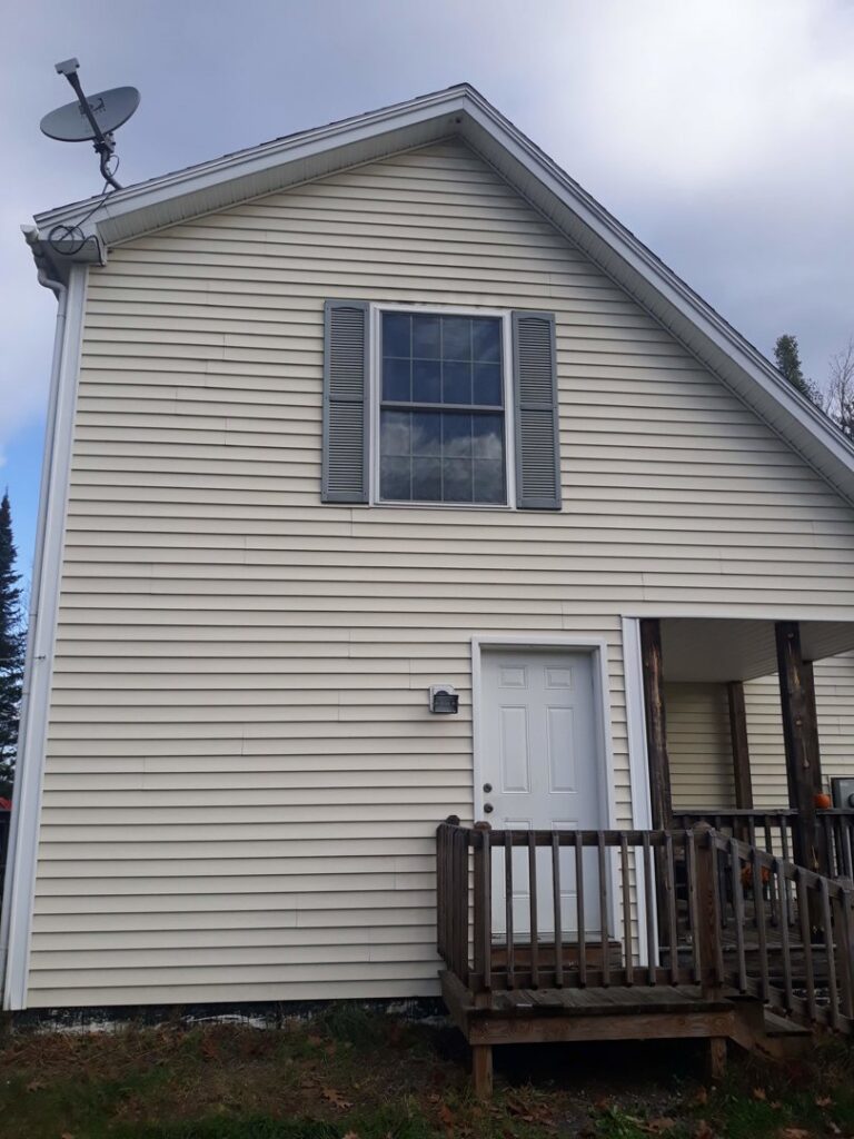 The exterior of a house with a porch, showing an area for potential handyman services by Phoenix's Cleaning Service, LLC in Rutland, VT.