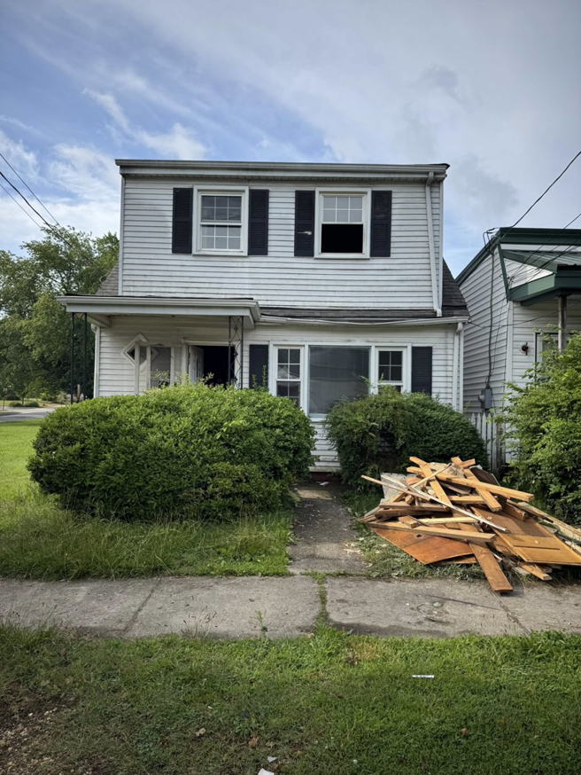 Exterior of a house undergoing renovation with construction debris in the front yard by Staley Contracting in Richmond, VA