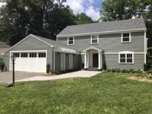 A house with a complete exterior renovation, including new siding and garage by Bartlett Brainard Products Co. in West Hartford, CT.