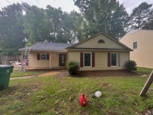 An exterior home renovation project in progress with a ladder and construction materials by JJConstruction203 LLC in Charlotte, NC.