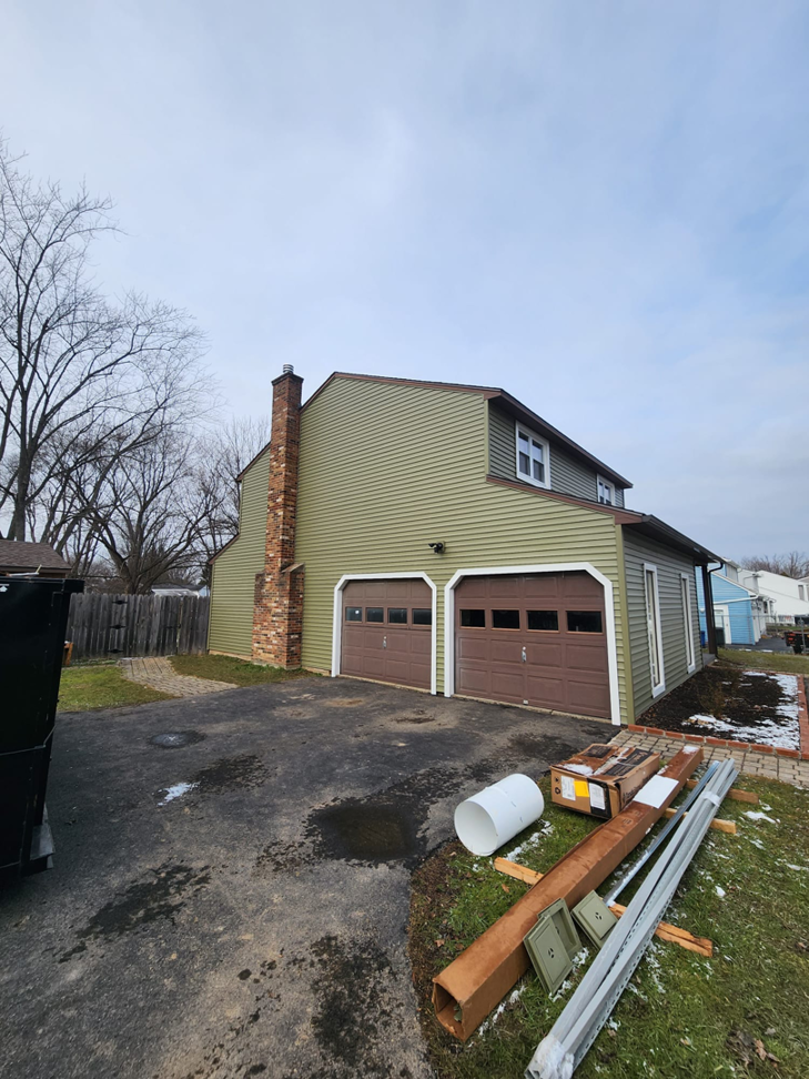 House exterior renovation with construction materials on site by The Best Larry Roofing corp in Mechanicsburg, PA