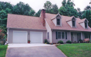 House exterior renovation with new roof, siding, and garage doors by Tim Moss & Sons Home Improvement in Greensboro, NC.