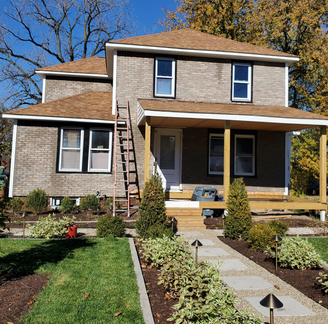 A house undergoing exterior renovation and porch construction by Indoor/Outdoor Home Repairs in Parma, OH.